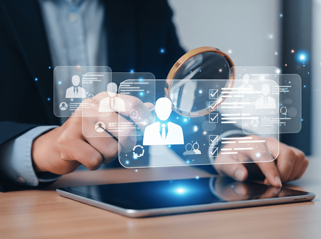 A business executive using a magnifying glass to scrutinise digital candidate profiles, representing the need for forensic biometric background checks during modern recruitment.
